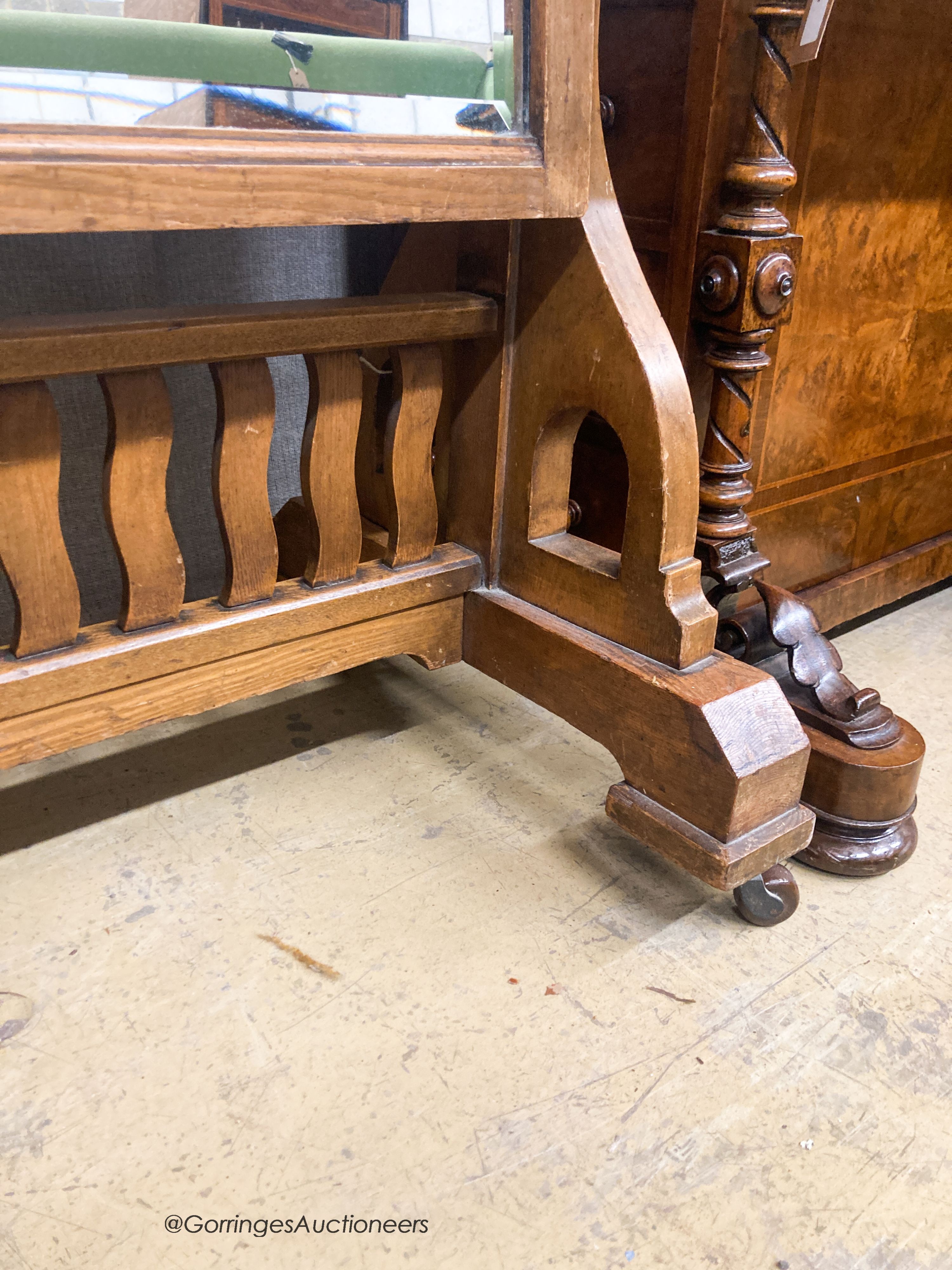 A Victorian Arts & Crafts oak cheval mirror, W.70cm H.172cm